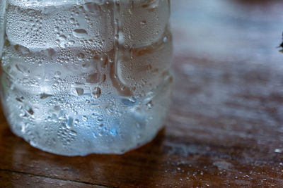 Close-up of wet glass on table