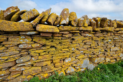 Close-up of old stack against wall