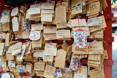 Close-up of japanese prayer blocks hanging from hooks