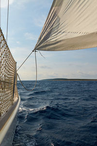 Sailboat sailing on sea against sky