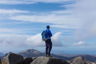 Rear view of man standing on mountain