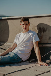 Portrait of a young man sitting outdoors