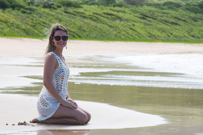 Portrait of smiling young woman on beach