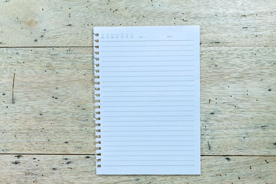 Directly above shot of blank white paper on wooden table