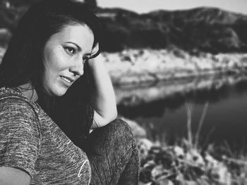 Portrait of young woman sitting outdoors