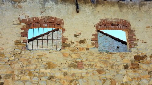 Low angle view of window on old building