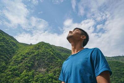 Man looking at mountain against sky