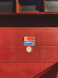 High angle view of warning sign on red board