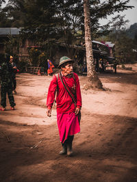 Woman with umbrella walking on sidewalk