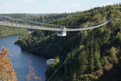 Low angle view of bridge over river against sky