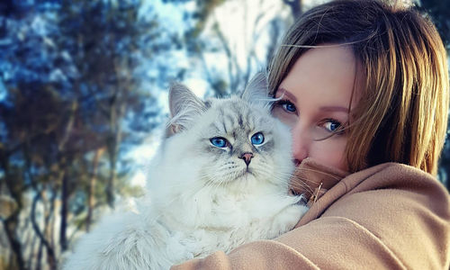 Close-up portrait of girl with cat