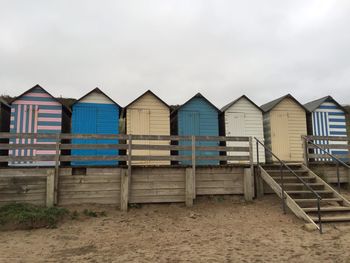 Beach houses in a row against clouds