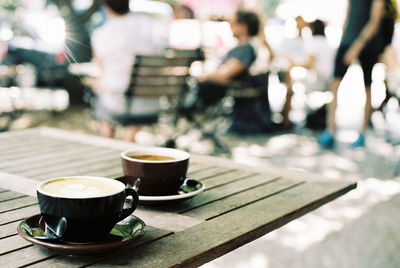 Close-up of coffee cups on table at cafe