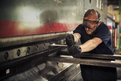 Manual worker using t wrench in metal industry