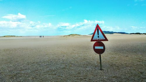 Lifeguard hut on beach against blue sky