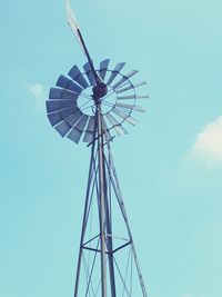 Low angle view of windmill against blue sky