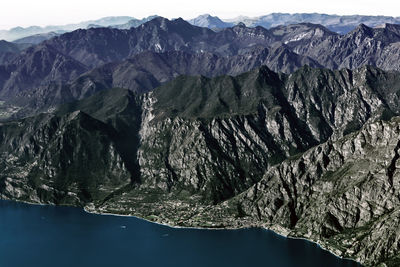 Garda lake and mountains rocky coast aerial panorama, italy