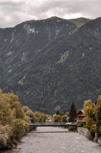 Scenic view of land and mountains against sky