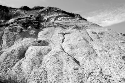 Low angle view of rock formations against sky