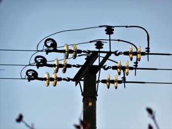 Low angle view of electric lamp against clear sky