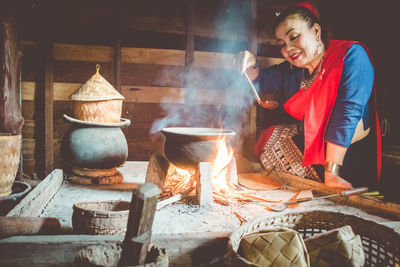 Portrait of young woman preparing food in workshop