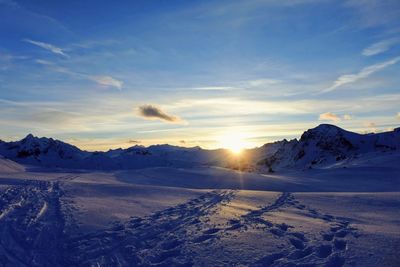 Scenic view of landscape against blue sky during sunset