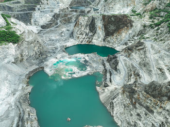 Open pit mine industry. limestone quarry with backhoe and truck in operation. heavy machinery