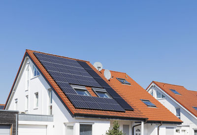 Germany, north rhine-westphalia, solar panels on tiled roofs of modern suburban house