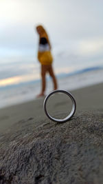 Woman standing on beach against sky