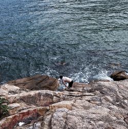 High angle view of man fishing on sea shore