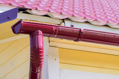 Red gutter on the roof top of house