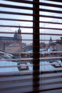 View of krakow skyline through window blinds in hotel