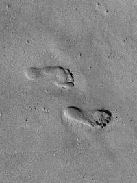 High angle view of footprints on beach