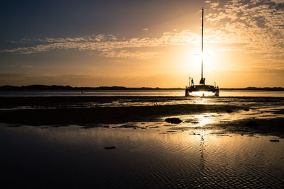 Silhouette of yacht moored on shore of ravenglass estuary