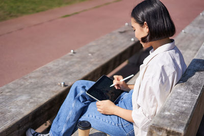 Side view of man using mobile phone