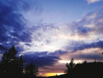 Silhouette of trees against sky at sunset