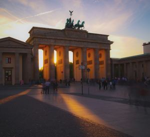 Group of people in city at sunset