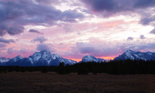 Scenic view of snowcapped mountains against sky during sunset