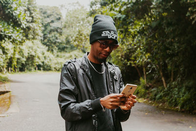 Portrait of young man using mobile phone