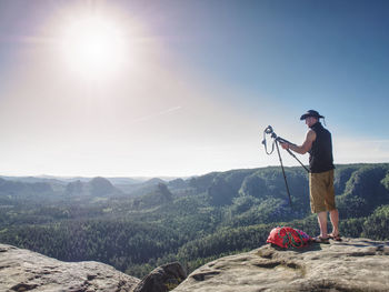 Man standing on mountain against sky