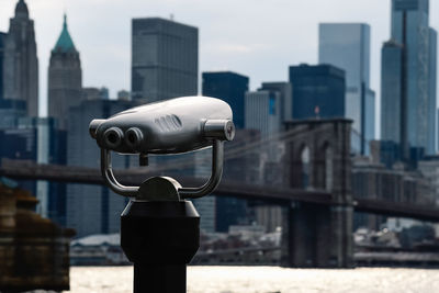 Binoculars against skyline of manhattan