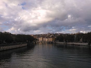 View of bridge over river against cloudy sky