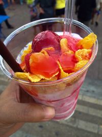 Close-up of hand holding ice cream