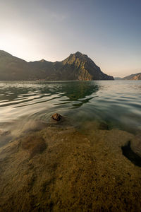 Scenic view of sea and mountains against sky