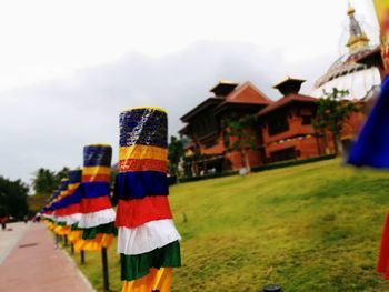 Close-up of multi colored umbrellas against sky