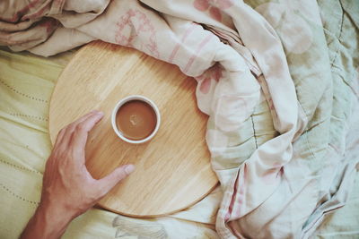 High angle view of woman holding coffee cup