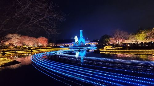 Illuminated city against sky at night