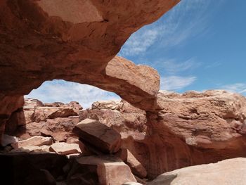 Rock formation against cloudy sky