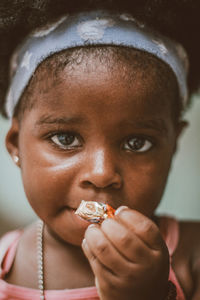 Close-up portrait of girl eating