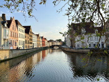 Canal amidst buildings against sky